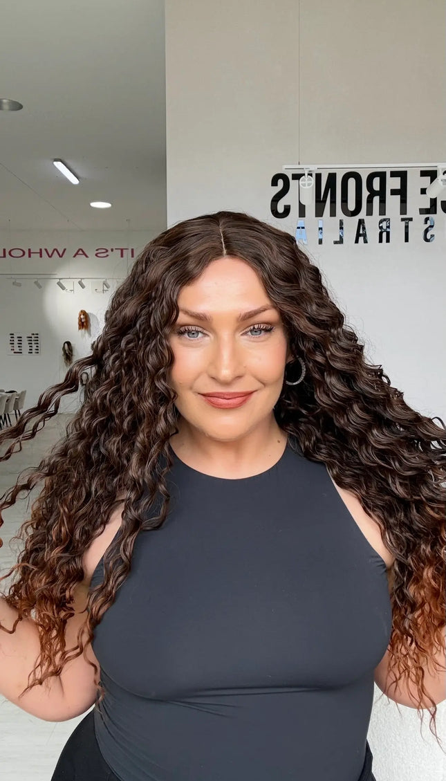 long length brunette curly hair with middle part and warmer chesnut ends, perfect for daily wear for those who love curly hair and volume.
