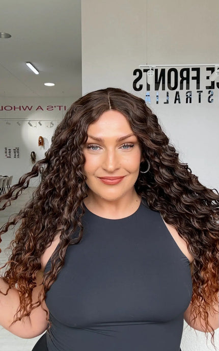 long length brunette curly hair with middle part and warmer chesnut ends, perfect for daily wear for those who love curly hair and volume.