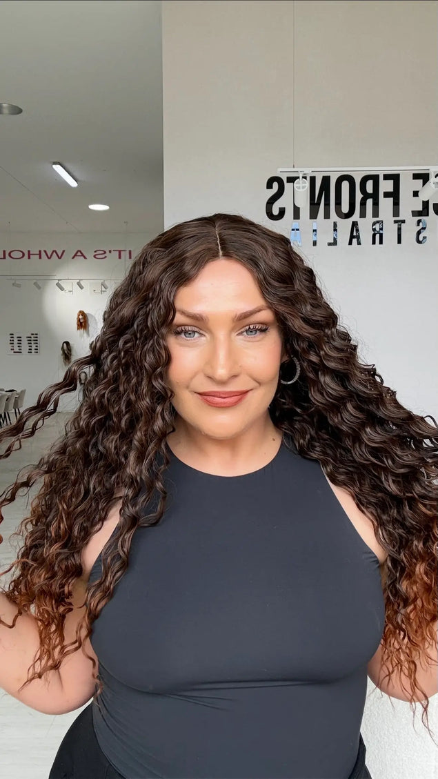 long length brunette curly hair with middle part and warmer chesnut ends, perfect for daily wear for those who love curly hair and volume.