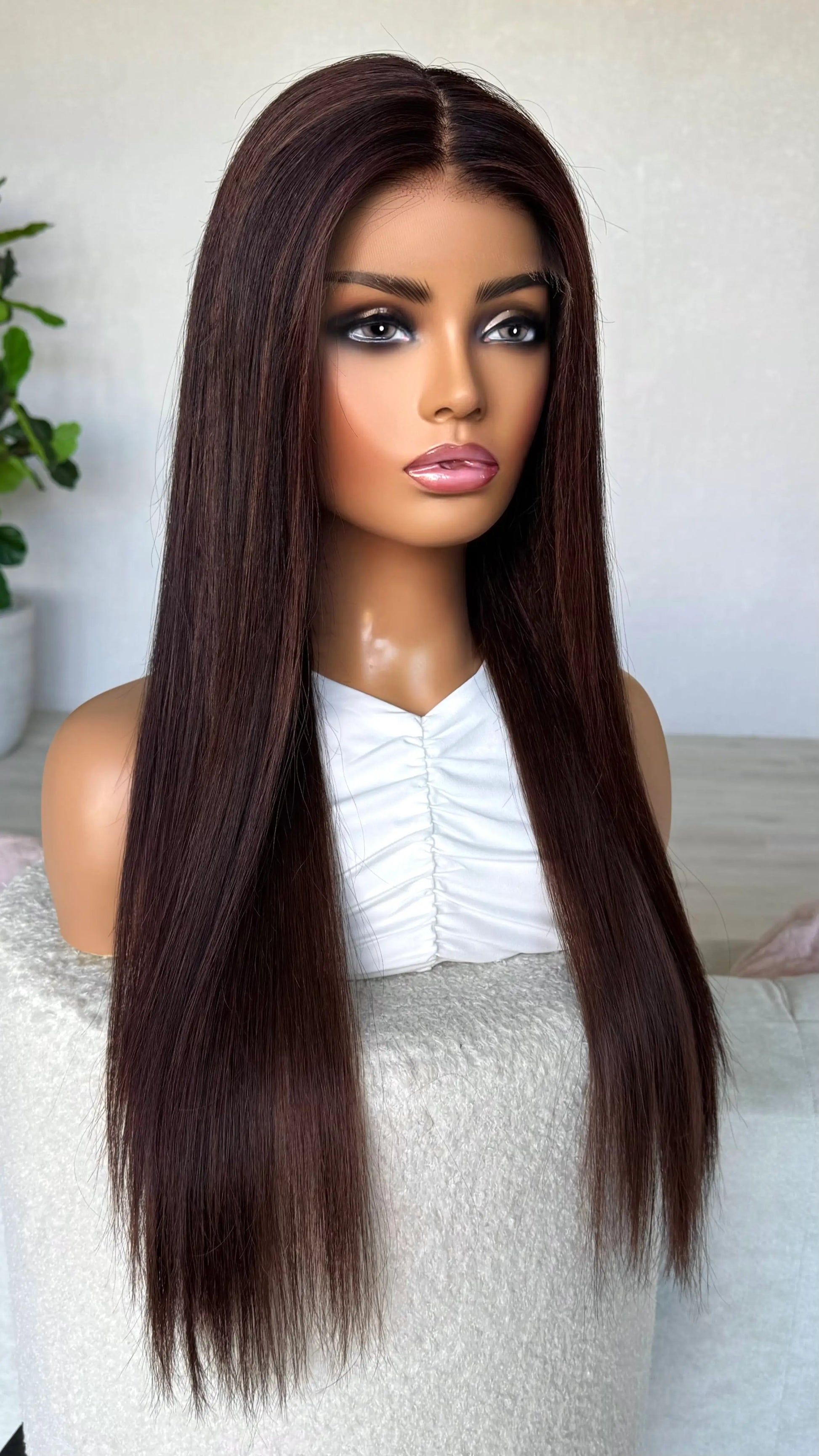 24 inches, straight hair lacefront wig, dark brunette with burgundy highlights throughout.