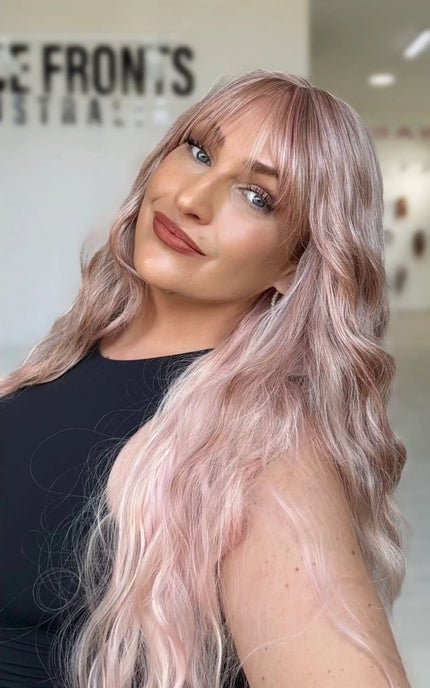 long length light pink long hair with middle part and long wispy fringe, half hair back, half forward.