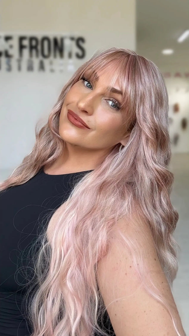 long length light pink long hair with middle part and long wispy fringe, half hair back, half forward.