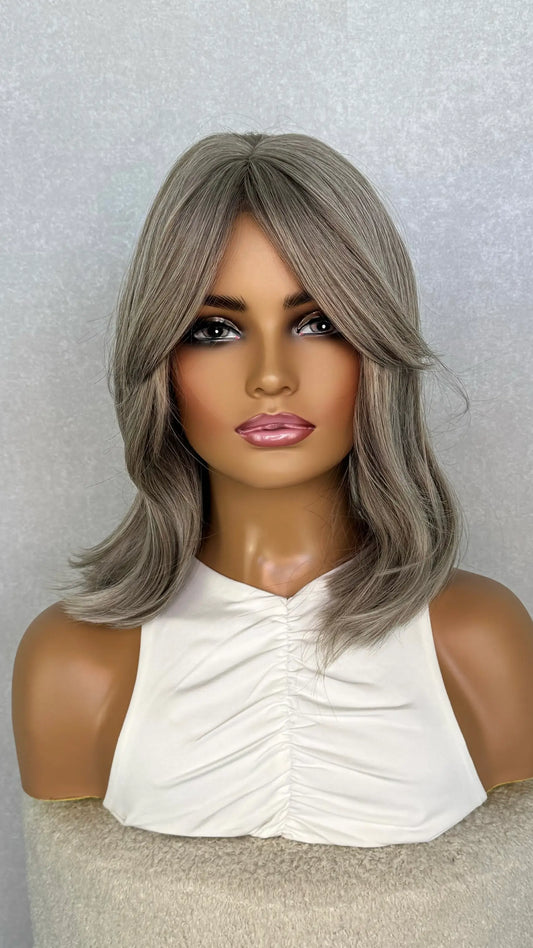a grey synthetic wig front on. showing 14 inche lengh of hair. curtain bangs/ fringe wig. heat safe. 
