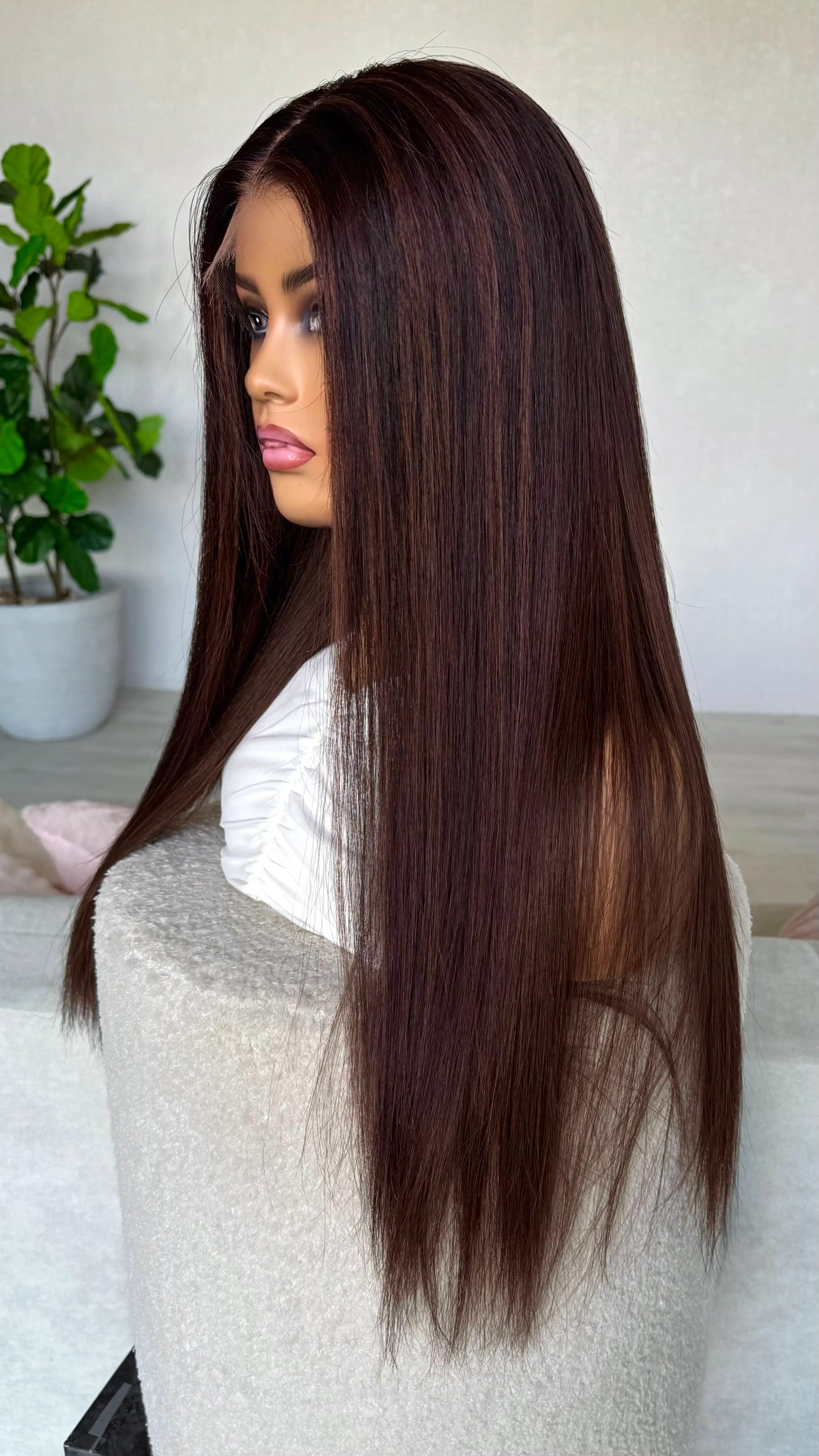 side on view, dark brown hair with highlights. brazilian remy hair wig, created in australia.