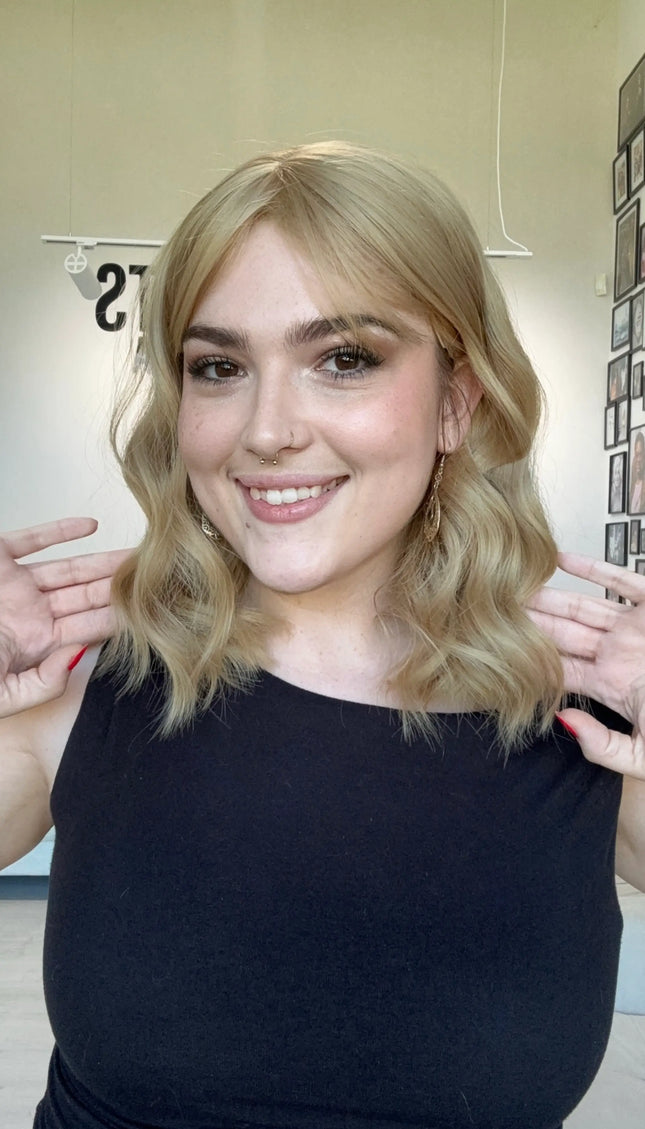 honey blonde hair middle part. heat safe topper with fringe. glueless cap