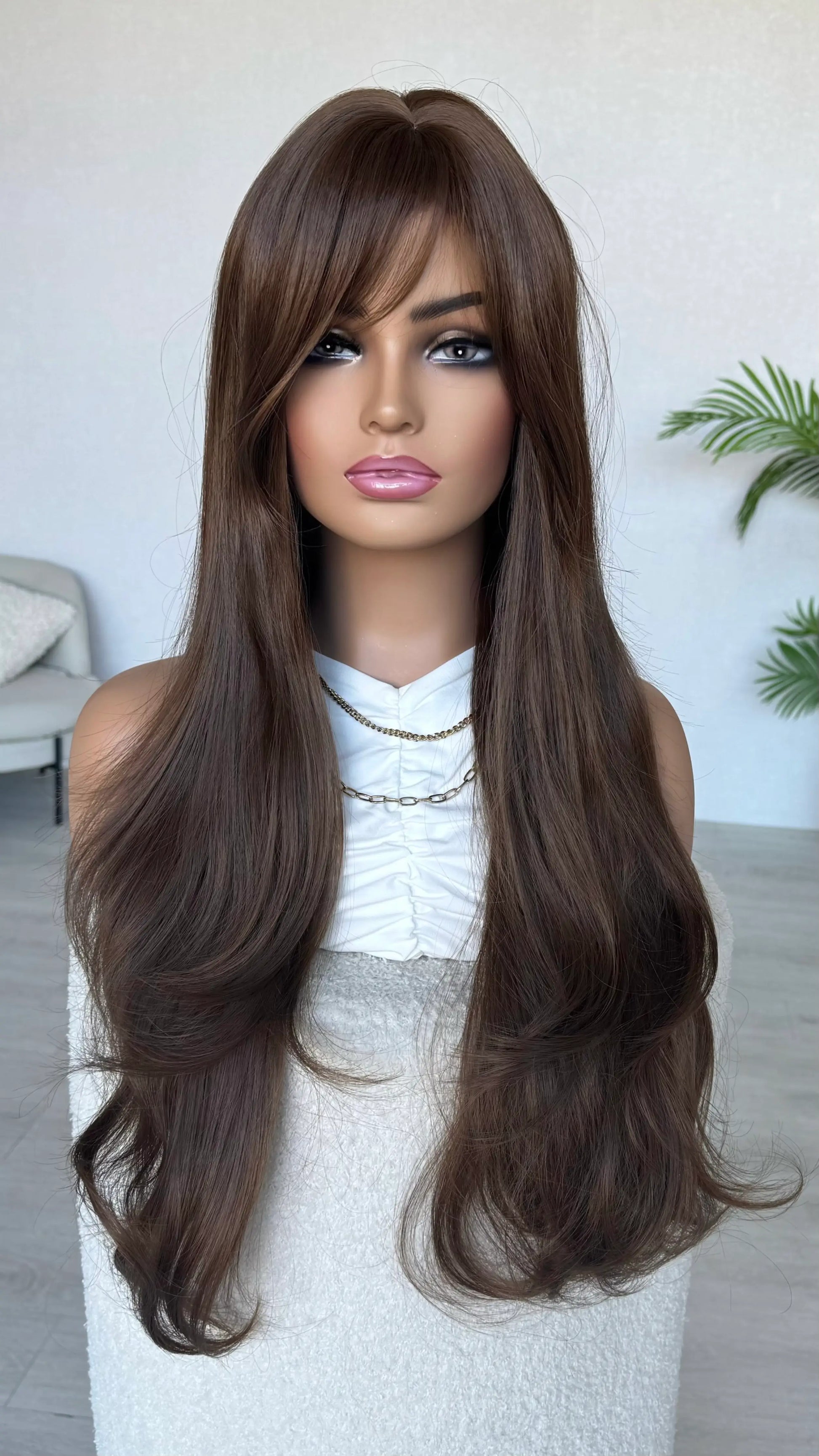 Mannequin head with long brown wig on a white background, australia wigs.