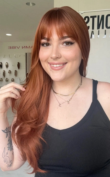 copper coloured synthetic wig with a fringe and light layers. natural looking wig.