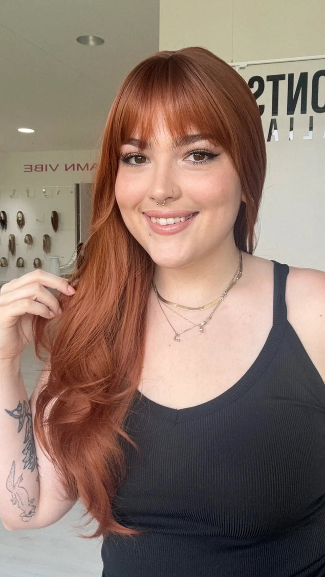 copper coloured synthetic wig with a fringe and light layers. natural looking wig.