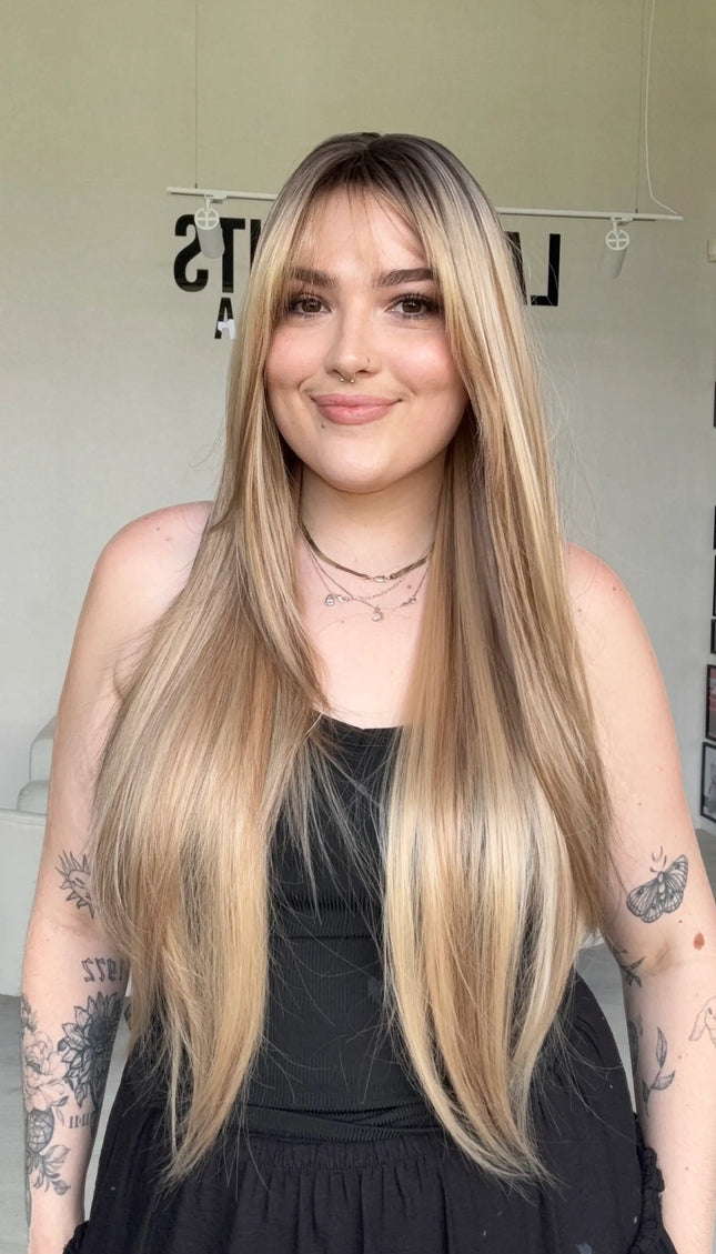 highlighted long blonde with layers middle part with fringe.