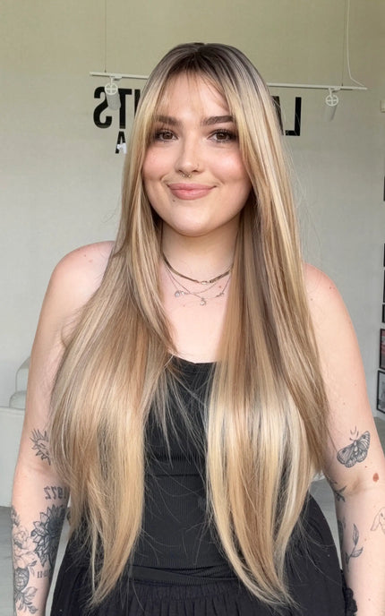 highlighted long blonde with layers middle part with fringe.