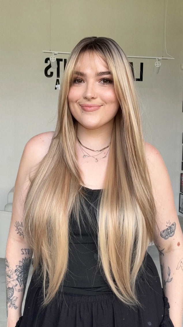 highlighted long blonde with layers middle part with fringe.