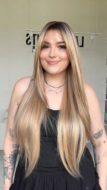 highlighted long blonde with layers middle part with fringe.
