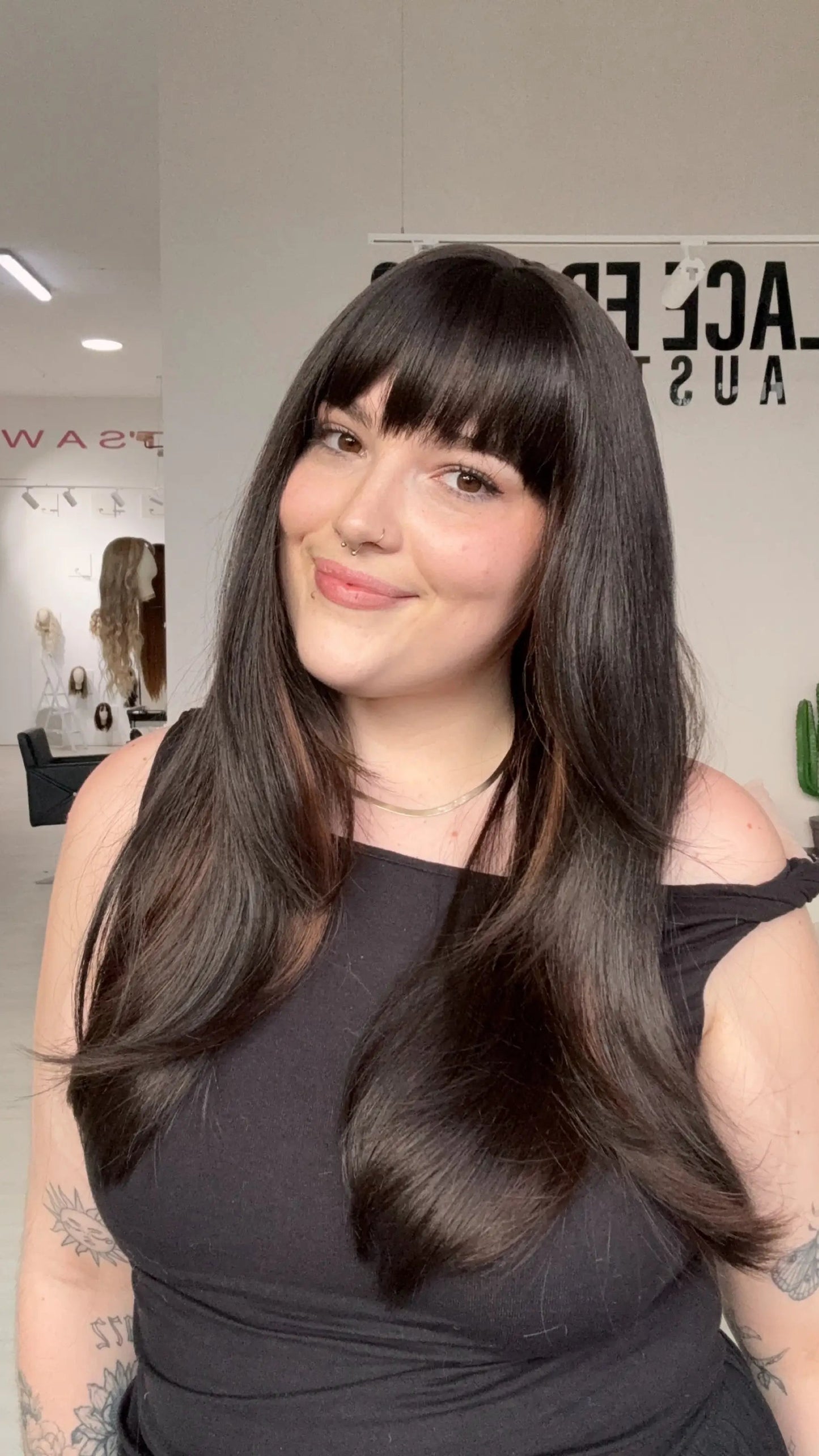 Highlighted dark brown fringe synthetic with heat safe hair and a glueless cap for easy beginner wear.