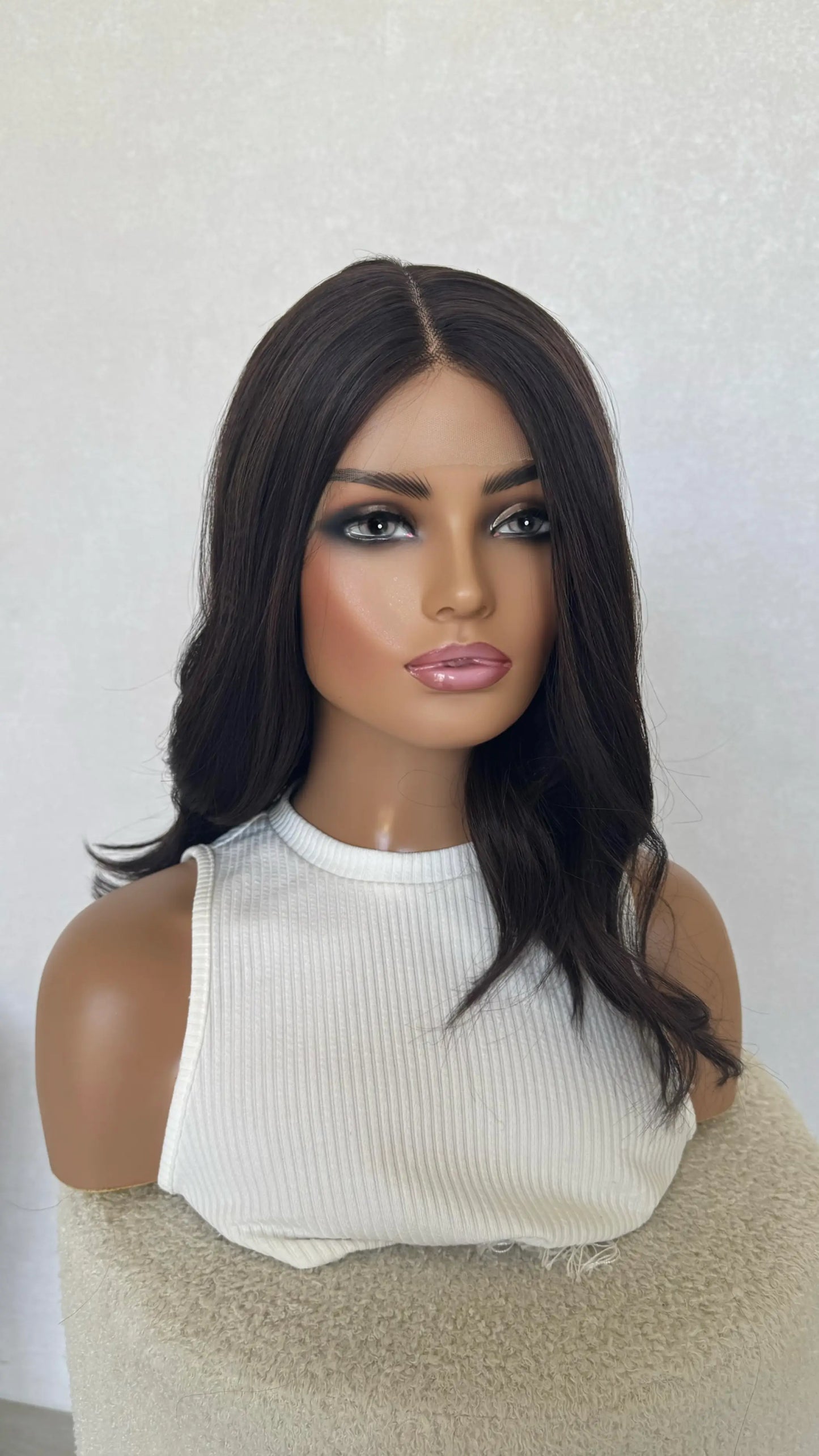 half hair back half forward, dark brunette, middle part wavy hair.