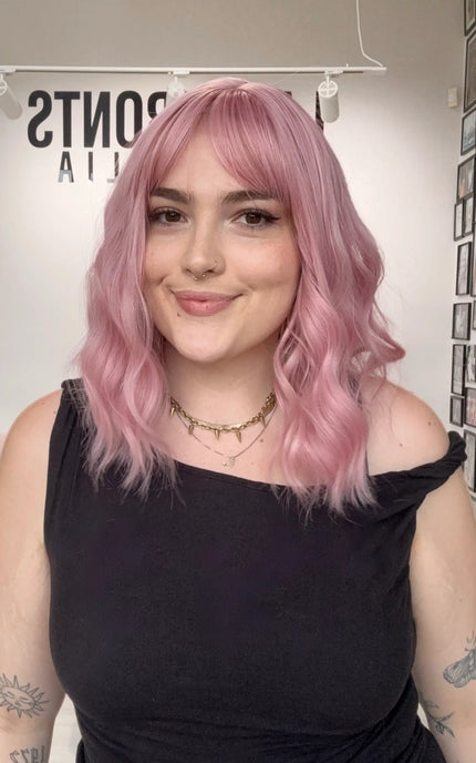 pink hair with middle part, wavy hair styling with fringe, heat safe and glueless pink hair synthetic wig australia.