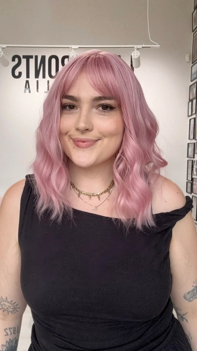 pink hair with middle part, wavy hair styling with fringe, heat safe and glueless pink hair synthetic wig australia.