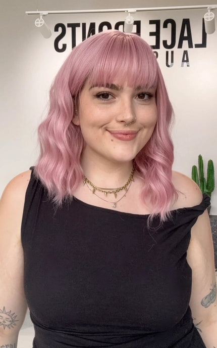 pink heat safe wig australia, wavy pink wig with fringe, middle part. glueless synthetic wig, gold coast. best synthetics pink hair.