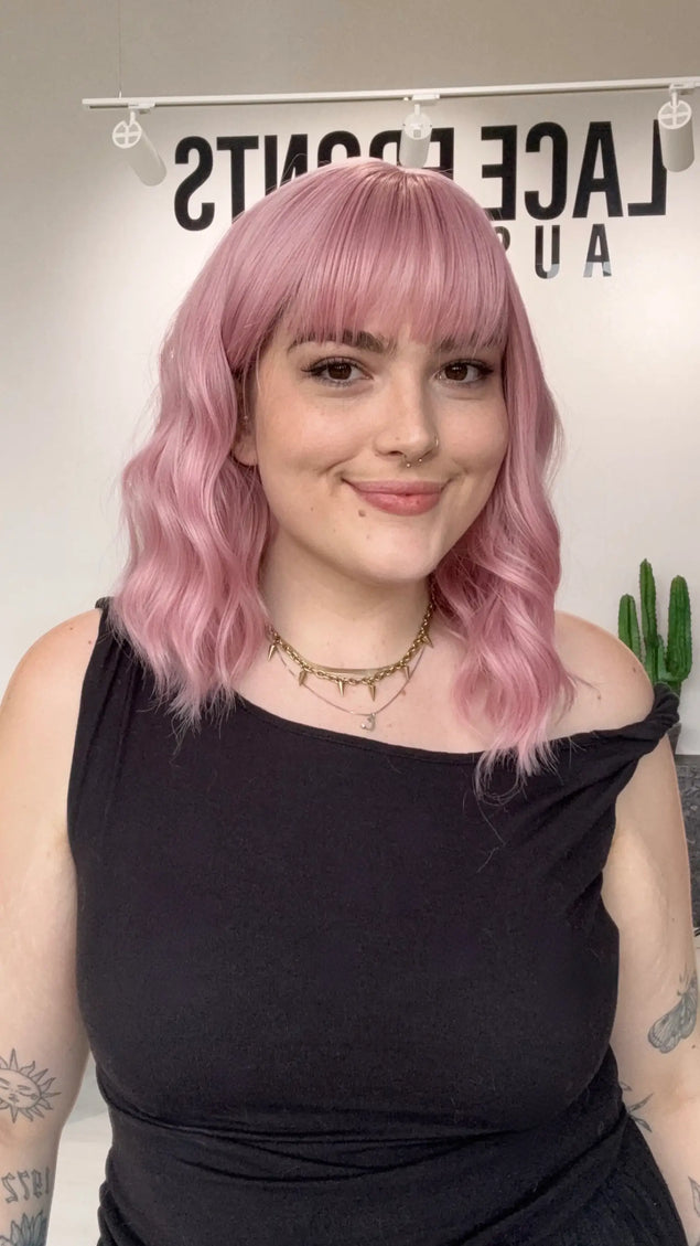pink heat safe wig australia, wavy pink wig with fringe, middle part. glueless synthetic wig, gold coast. best synthetics pink hair.