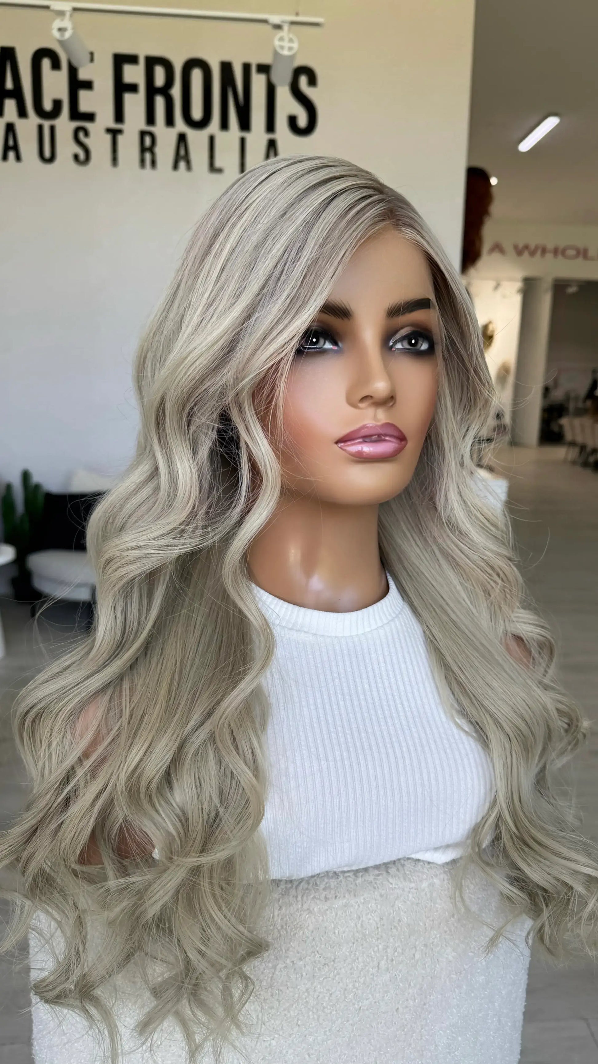 human hair lace front wig, platinum blonde with soft lowlights at root, 26 inch curled hair.