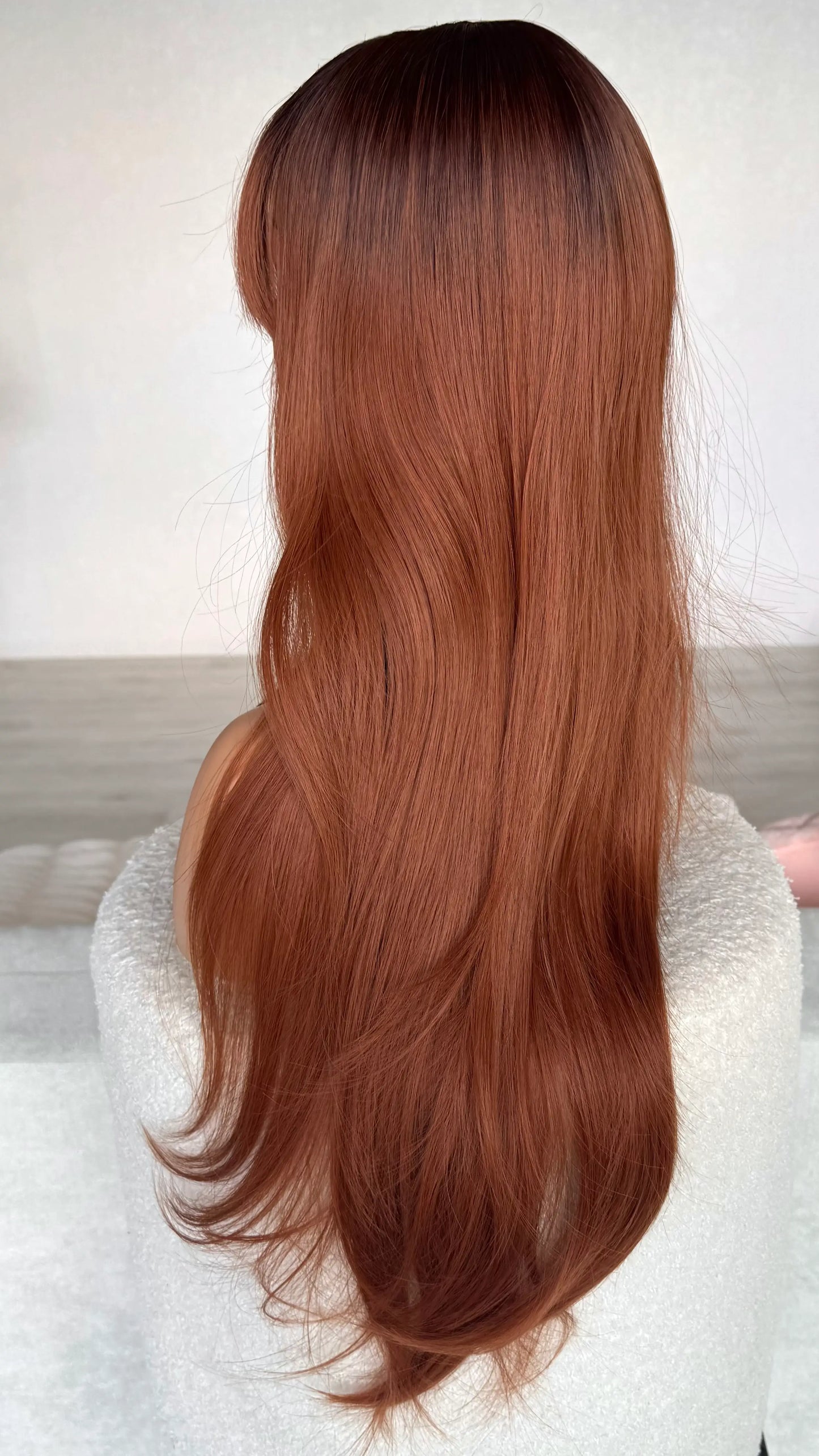 side on view, showing colour of heat safe hair, red copper with dark root.