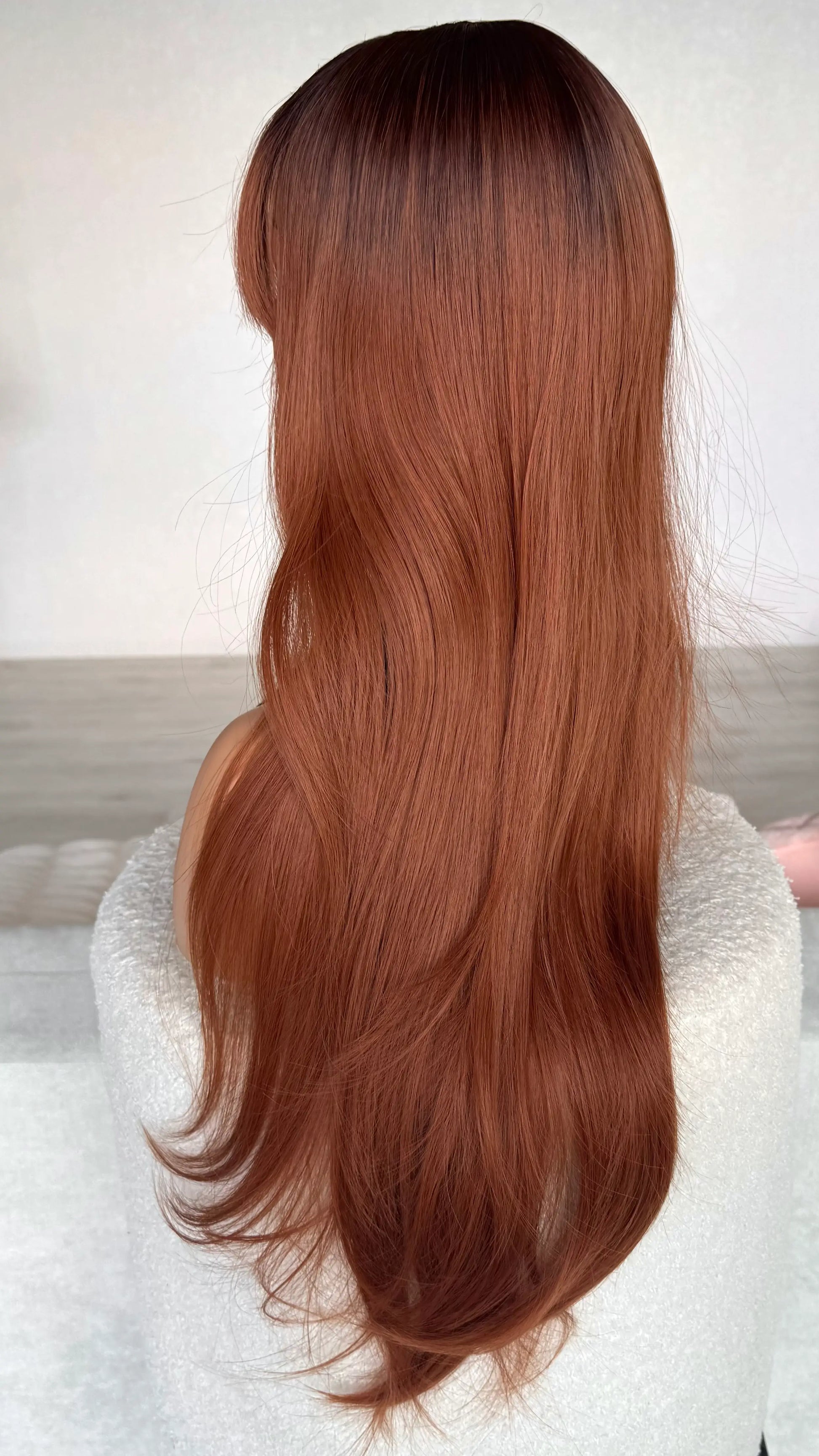 side on view, showing colour of heat safe hair, red copper with dark root.