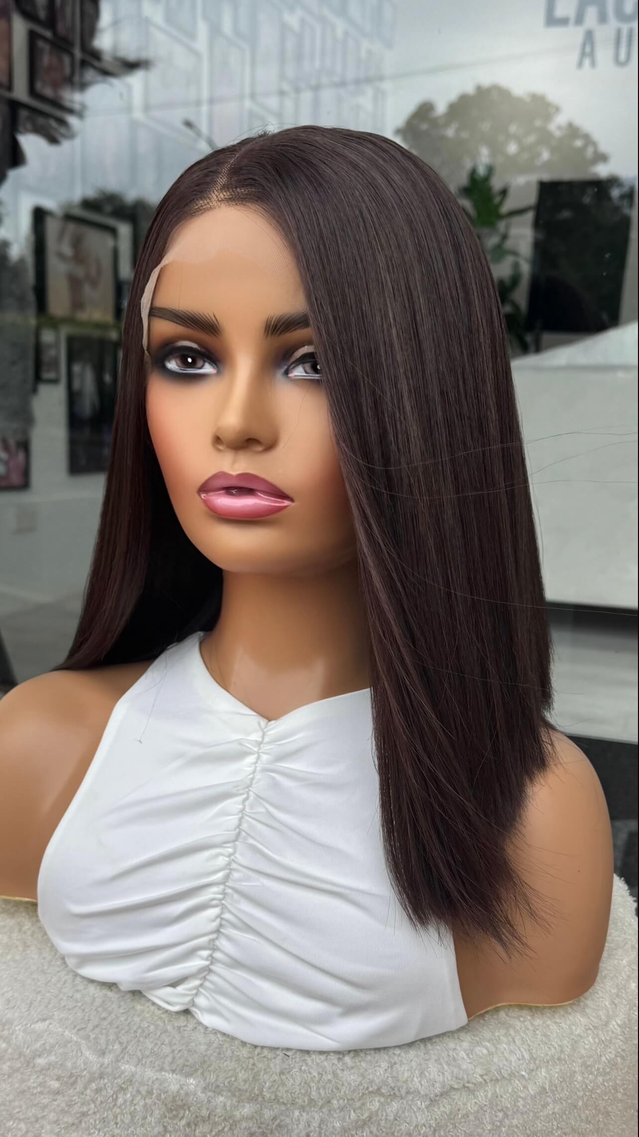 brunette wig from the side on, showing straight dark brunette hair, silky hair. lacefront wig. 