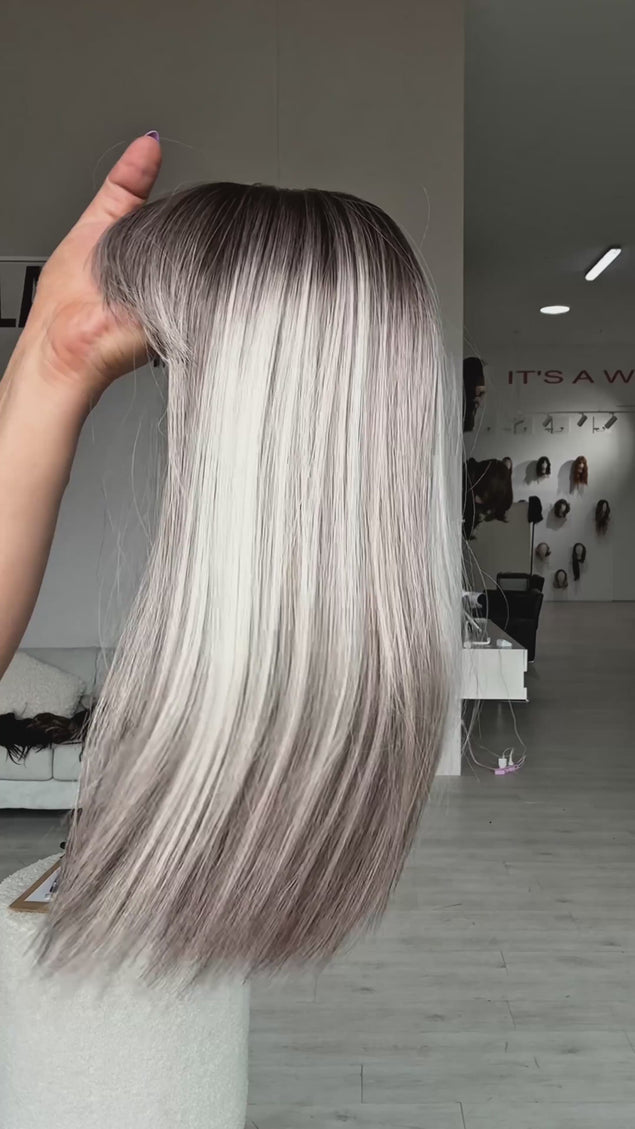 ash grey balayage, with dark black root, soft blonde ash highlights throughout. glueless cap with heat safe hair.