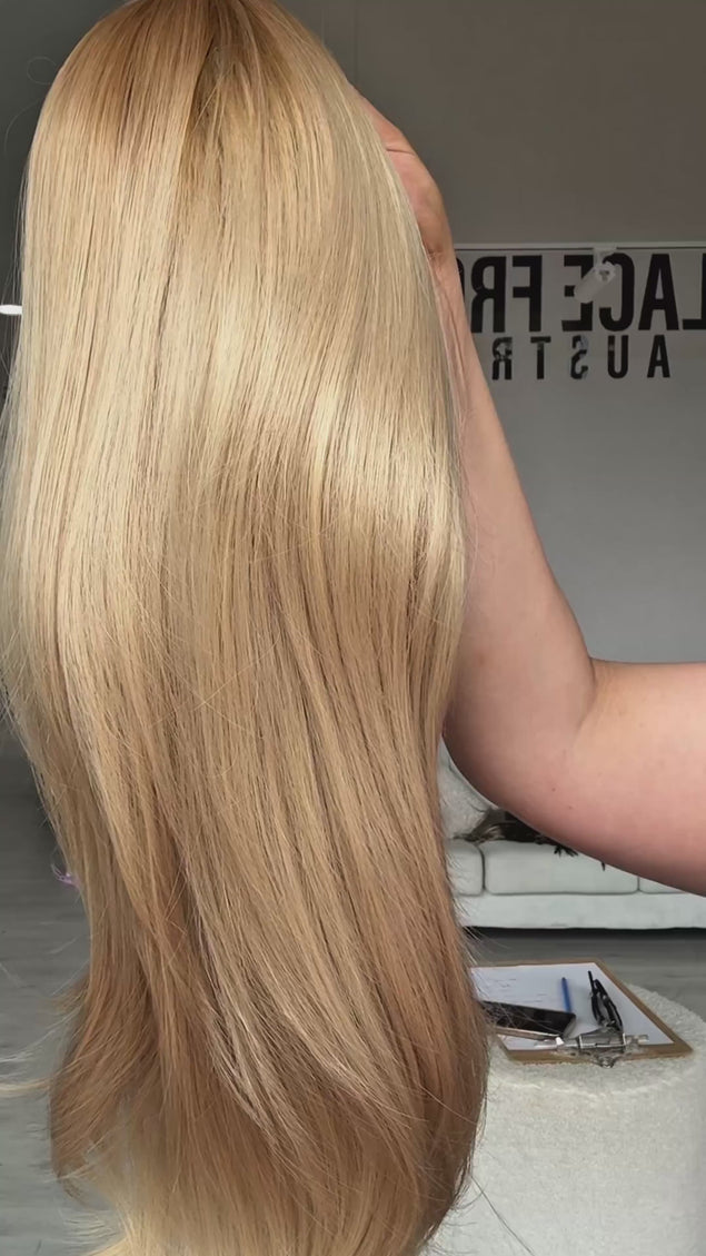 golden blonde with gold root, long straight hair wig with middle part and long curtain bang fringe parted to the side, light layers throughout for movement. heat safe fibres.