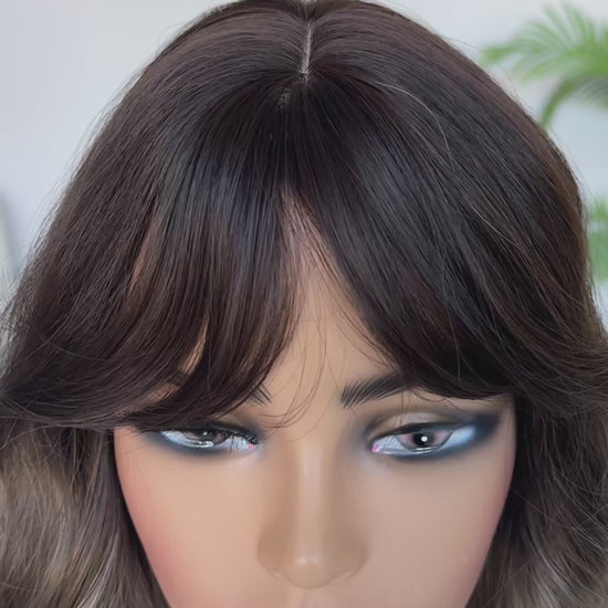 ash brown ombre middle part with curtain bangs wavy hair.