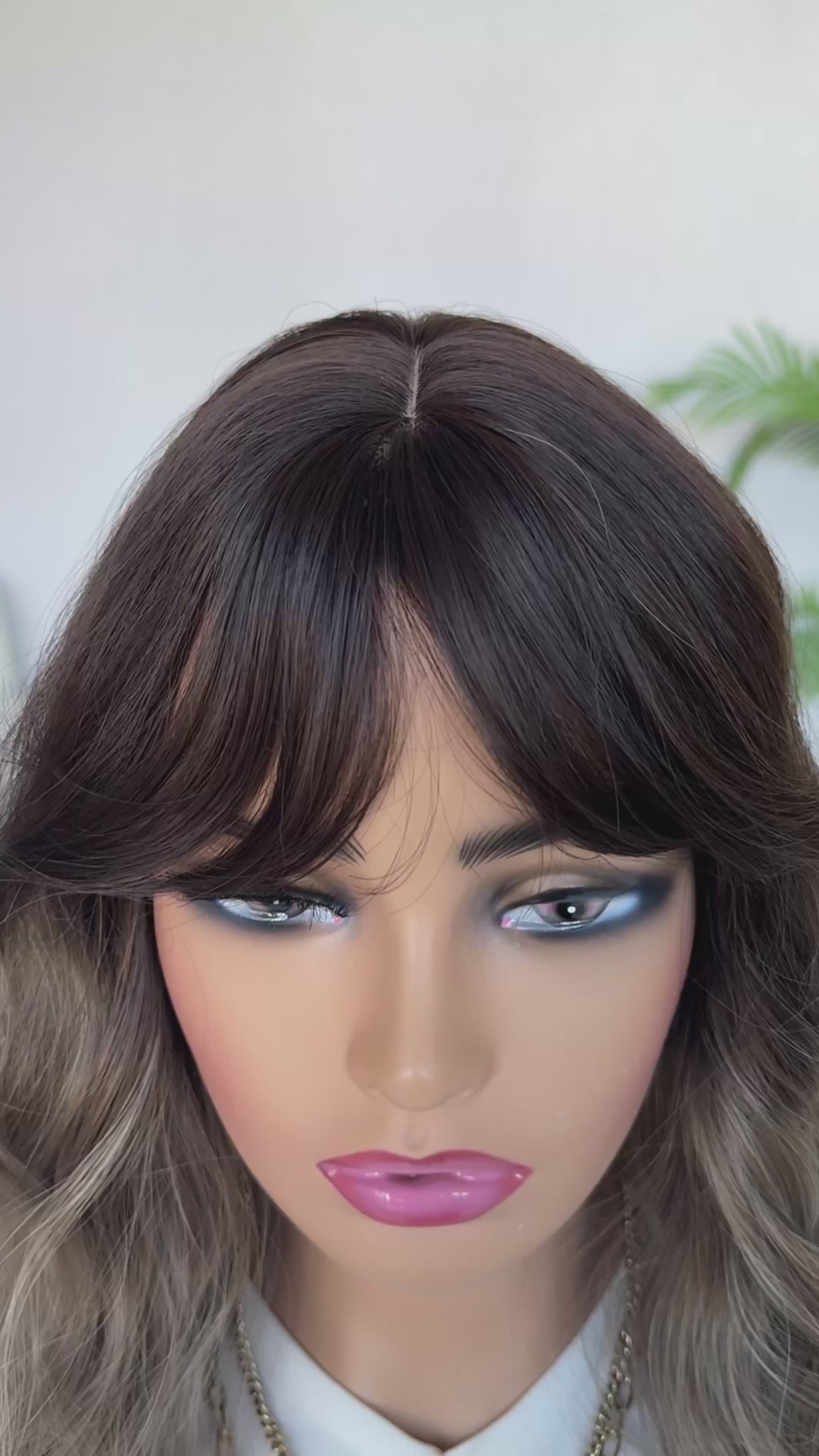 ash brown ombre middle part with curtain bangs wavy hair.