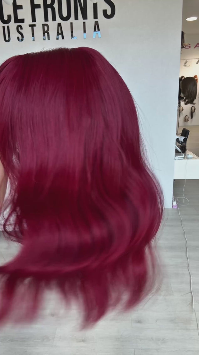 red wavy wig with long bob style, middle part with long fringe. deep red colour with light beachy wave throughout, heat safe hair with glueless wig cap perfect for daily wear.