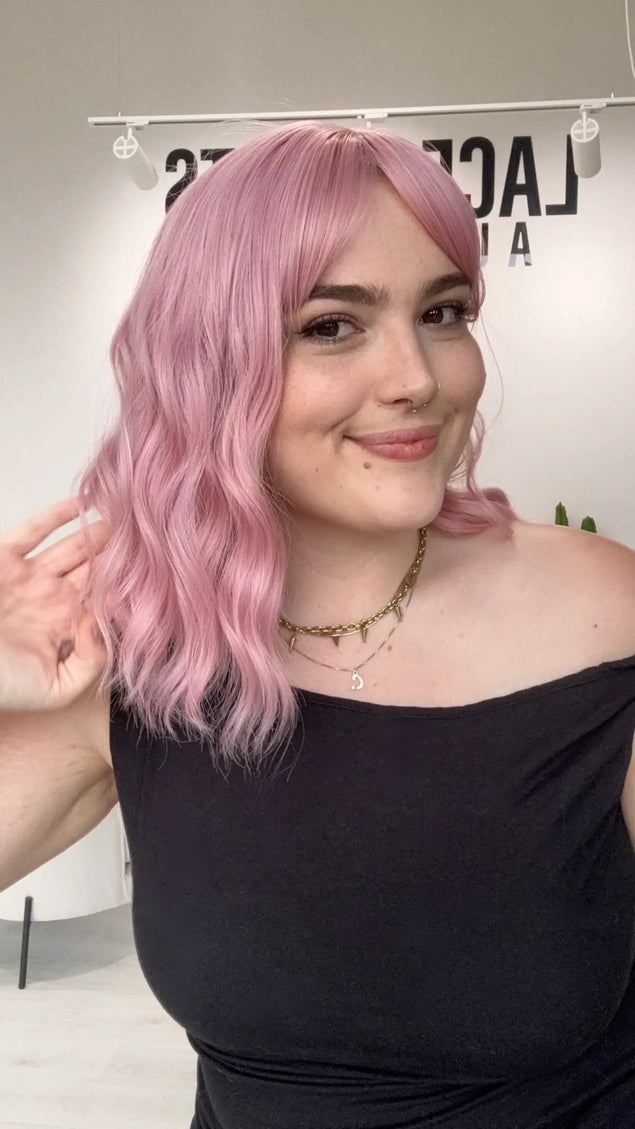 natural feeling synthetic wig, wavy pink hair with middle part and fringe, heat safe and glueless synthetic wig australia, gold coast.