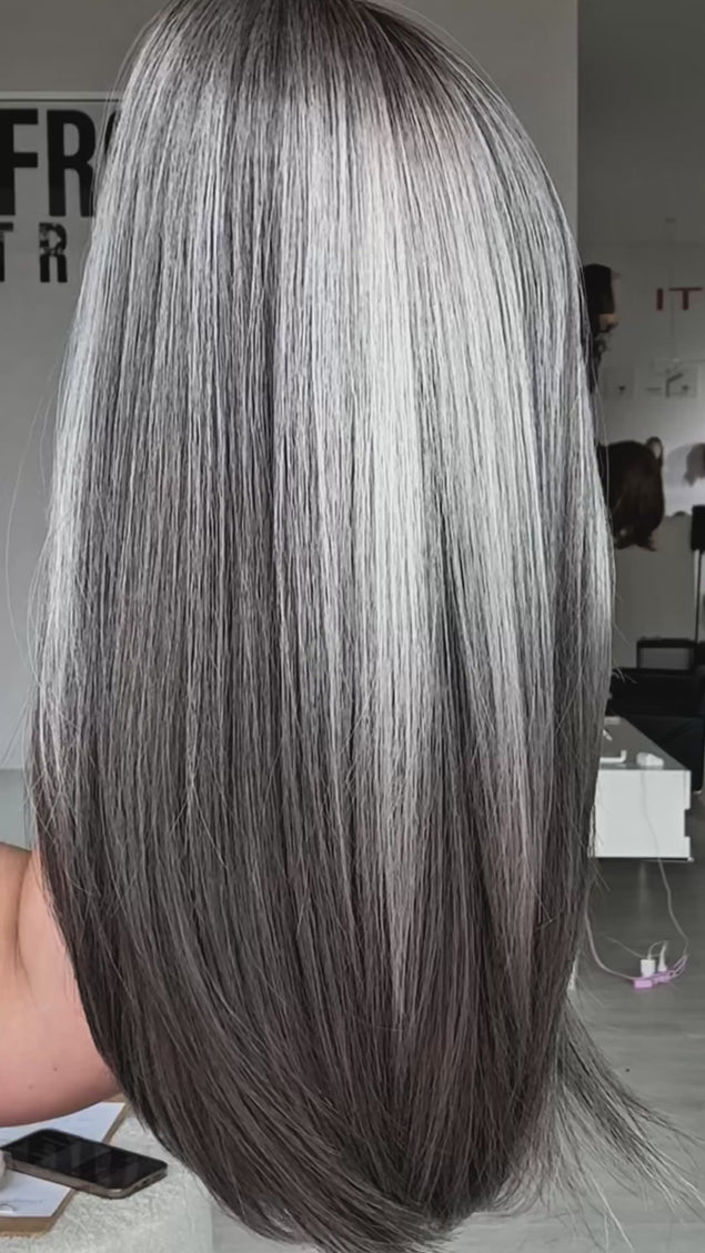 long grey bob with highlighted ash blonde throughout, straight hair wig with middle part and long curtain bang fringe parted to the side. heat safe hair with glueless cap.