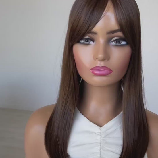 chestnut brunette middle part topper, fringe parted to the side.