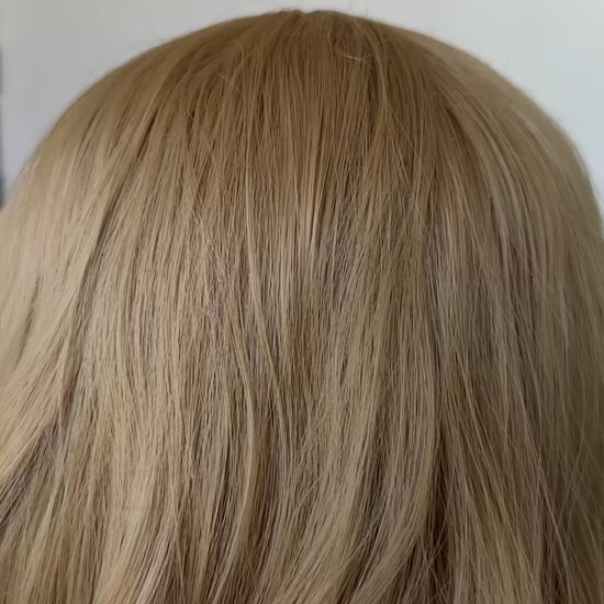 honey blonde hair, wavy synthetic wig, glueless and heat safe middle part with longer fringe.