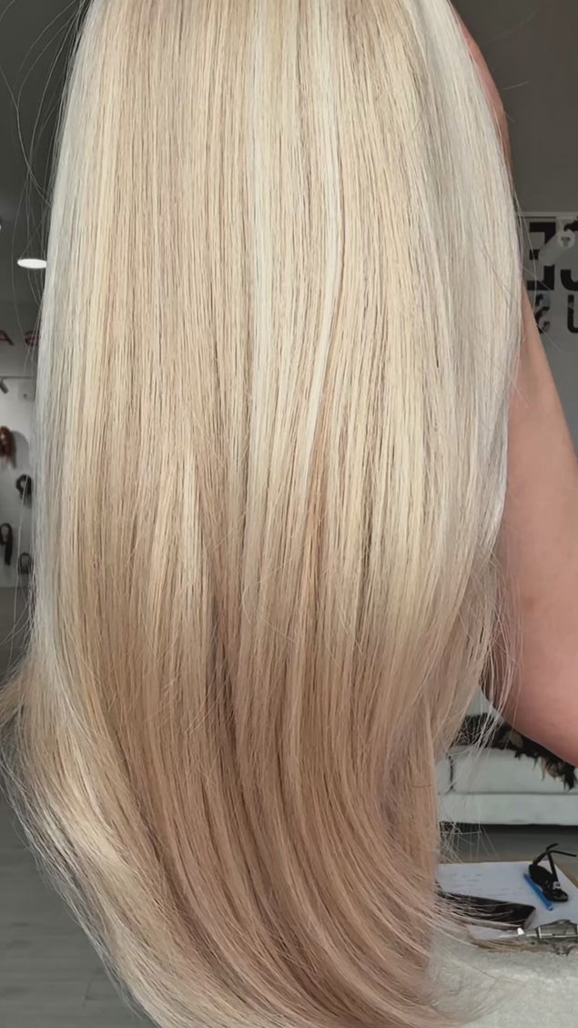 sabrina wig, light warm blonde, straight hair with layers and middle part, long fringe parted to the side, medium length hair to chest.