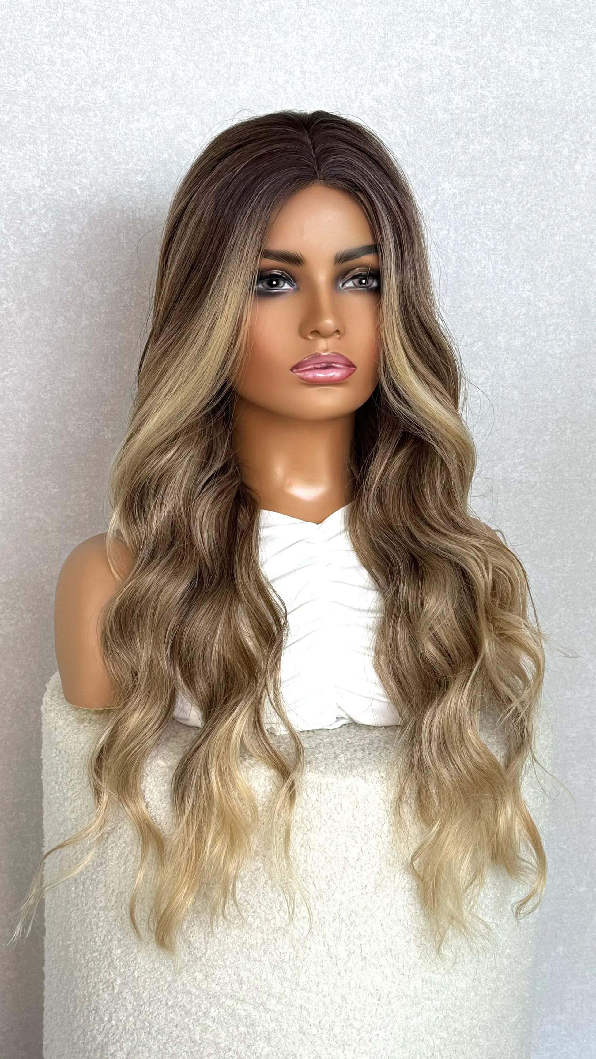 lacefront t-part wig from the front view. showing brunette hair with highlights and money piece. 