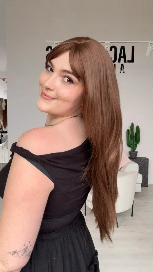 natural looking long hair synthetic wig with heat safe hair and a glueless cap.