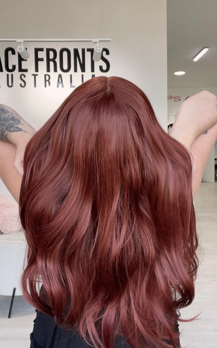 natural looking lace front glueless wig with long red hair.