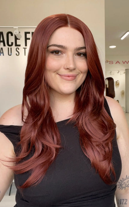 a realistic looking red hair lace front synthetic wig with heat safe fibres, chageable parting and a glueless cap for everyday wear.