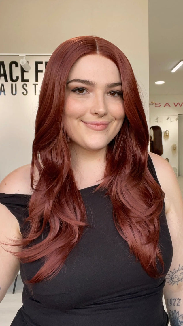 a realistic looking red hair lace front synthetic wig with heat safe fibres, chageable parting and a glueless cap for everyday wear.