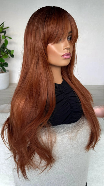 side on view, red copper wig, long straight hair with a fringe. heat safe.