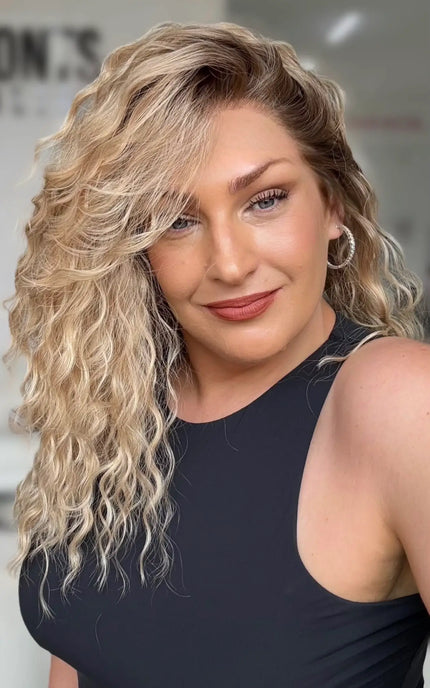 right side part honey blonde curly lace front wig. mid length 16-19 inch length with layers throughout for moevement.