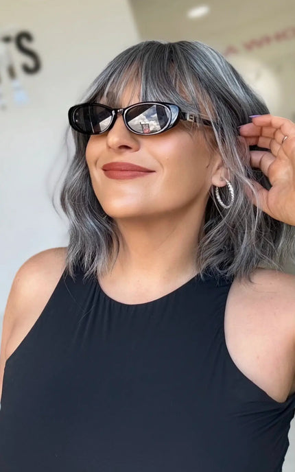right side view tucking grey silver hair behind ears, fringe and middle part, with heat safe synthetic hair for easy styling up to 180 degrees celcius.