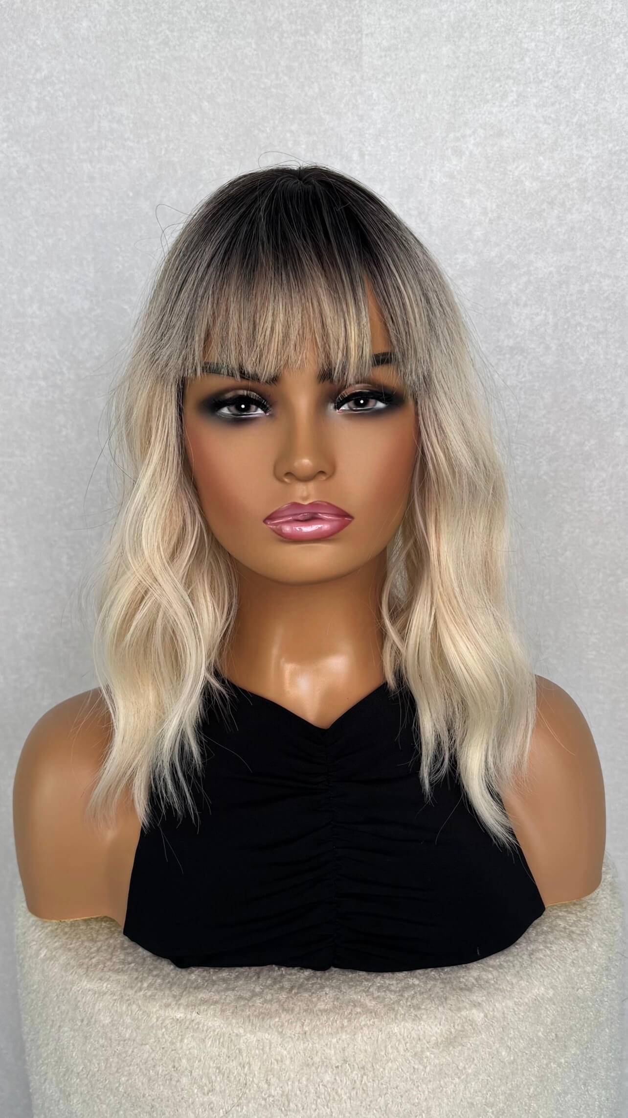 a wavy platinum blonde wig. 14 inches, with a dark root. 