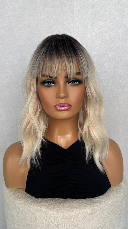 a wavy platinum blonde wig. 14 inches, with a dark root. 