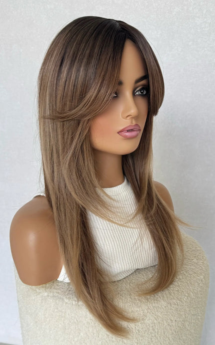layered synthetic wig with layers and curtain bangs.