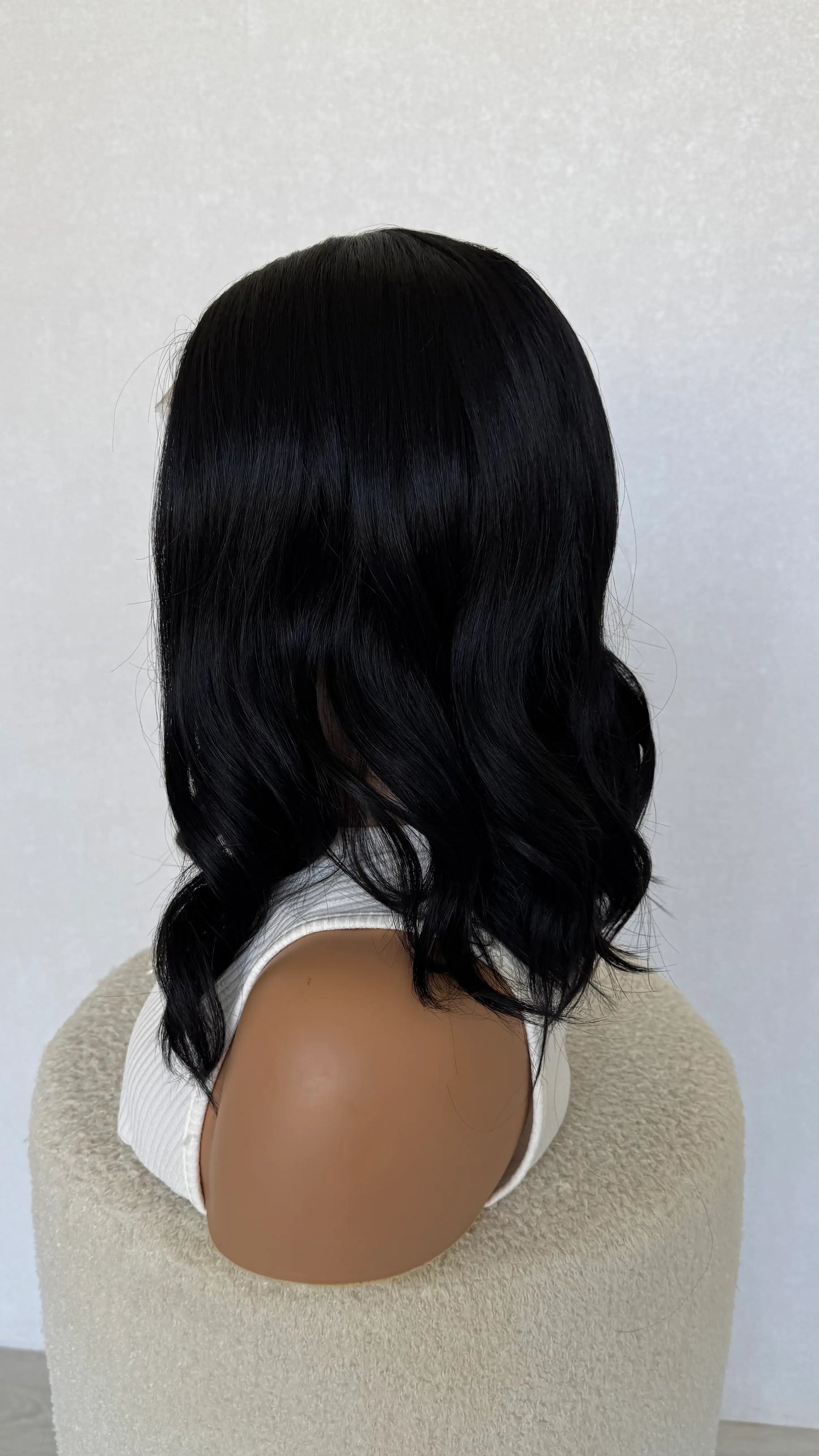 side on view, lacefront black synthetic wig, heat safe, glueless wig.