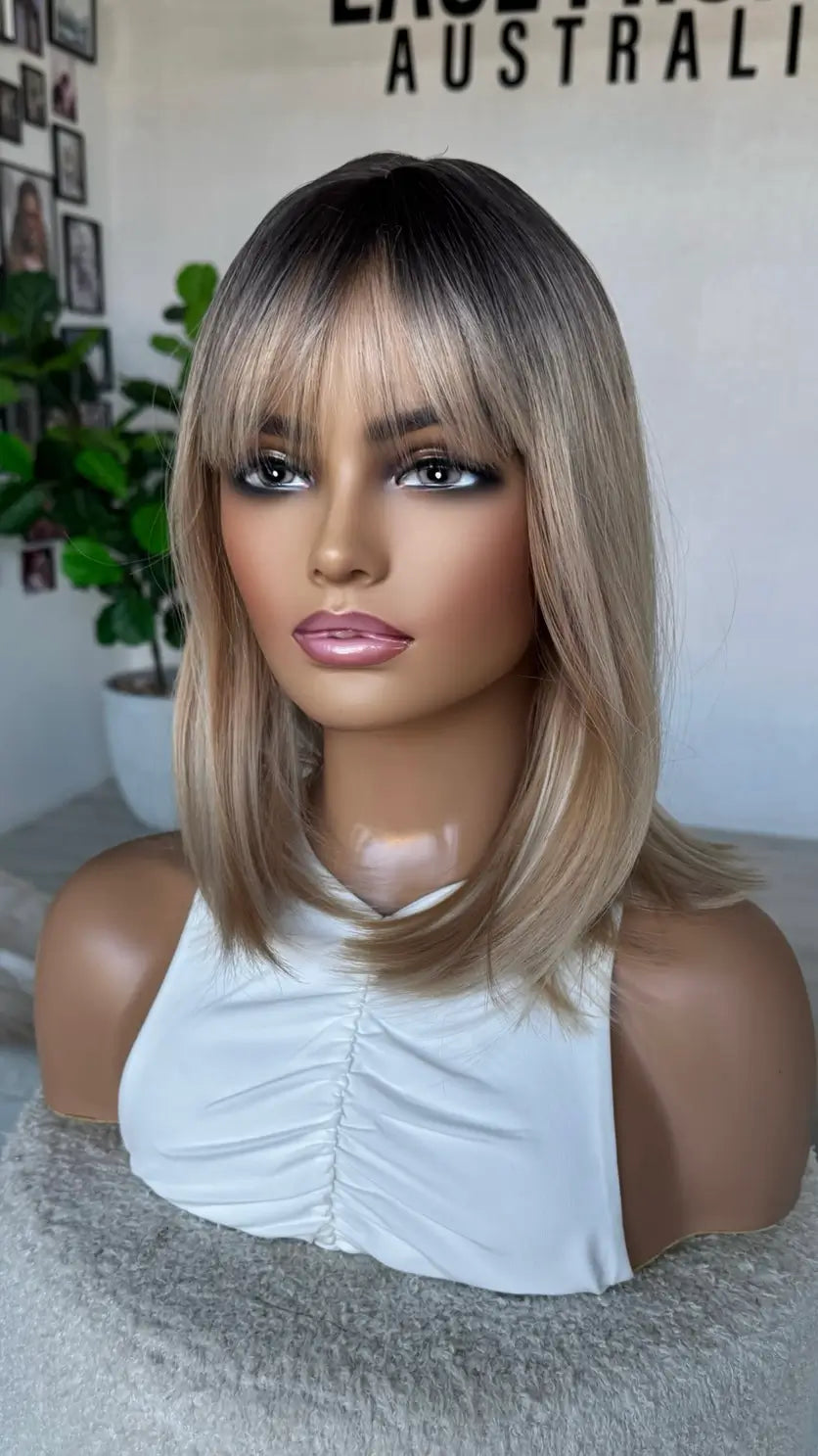 bob length hair with middle part, dark root to mixed blonde bob