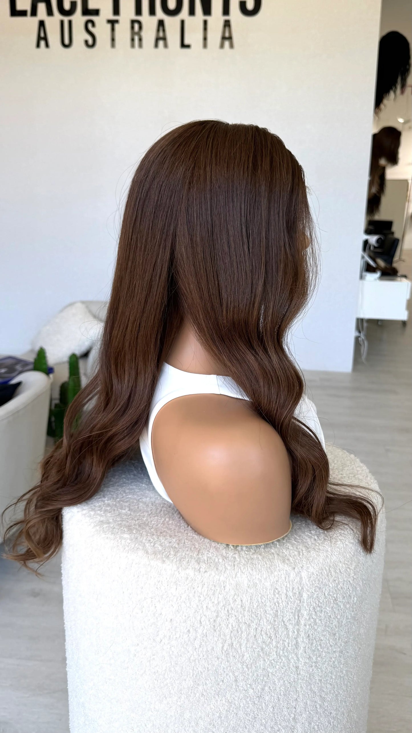dark brunette warm toned, side on view, 24 inches, wavy hair. medical lace front wig.